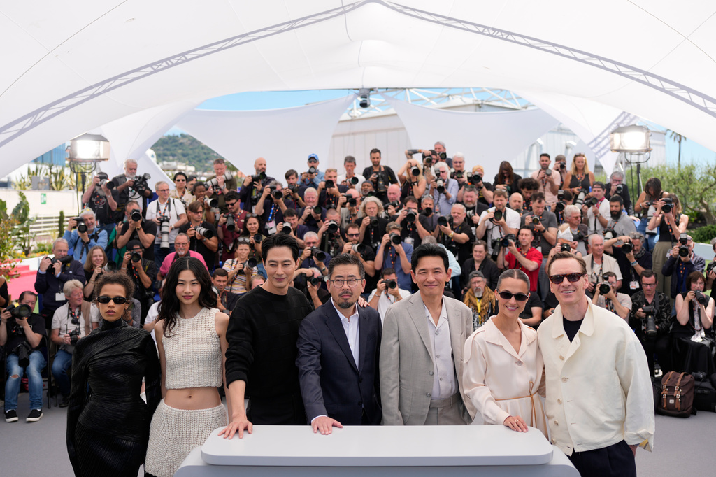 Taylor Russell, from left, Hoyeon, Zo In-sung, director Na Hong-jin, Hwang Jung-min, Alicia Vikander and Michael Fassbender pose for photographers at the photo call for the film 'Hope' during the 79th international film festival, Cannes, southern France, Monday, May 18, 2026. (AP Photo/John Locher)