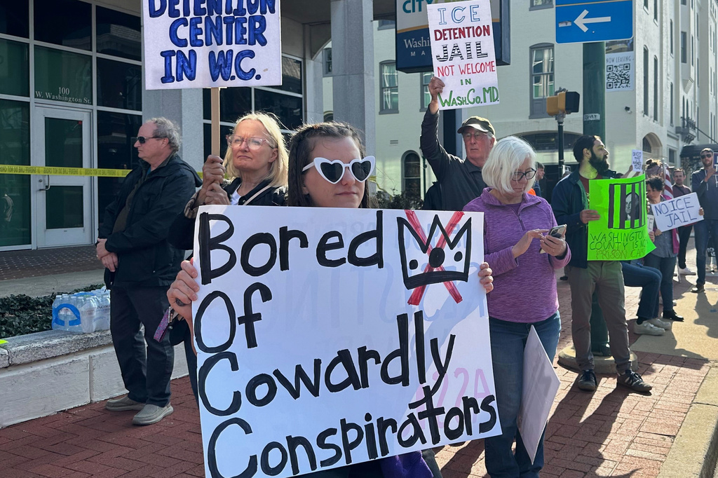 Protesters rally against a planned immigration detention facility outside a Washington County Commission meeting in Hagerstown, Md., Tuesday, March 31, 2026. (AP Photo/Nathan Ellgren)