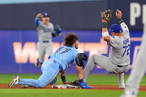 Los Angeles Dodgers second baseman Miguel Rojas (72) fields a throw to force out Toronto Blue Jays' Addison Barger (47) at second to turn a double play to end Game 6 of baseball's World Series in Toronto, Friday, Oct. 31, 2025. (Frank Gunn/The Canadian Press via AP) Los Angeles Dodgers second baseman Miguel Rojas (72) fields a throw to force out Toronto Blue Jays' Addison Barger (47) at second to turn a double play to end Game 6 of baseball's World Series in Toronto, Friday, Oct. 31, 2025. (Frank Gunn/The Canadian Press via AP)