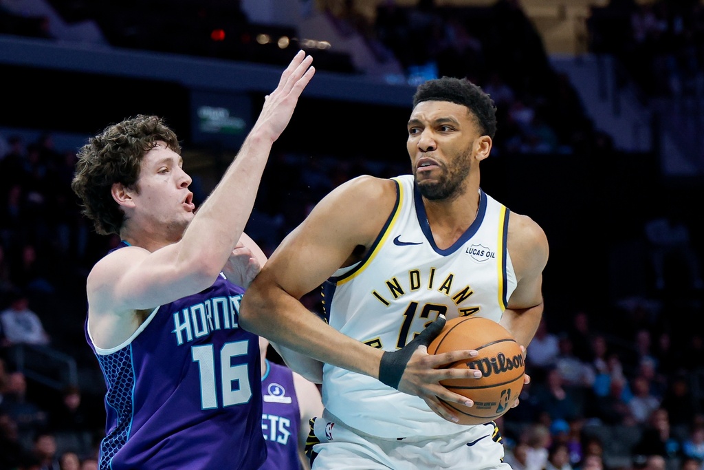 Indiana Pacers center Tony Bradley, right, drives into Charlotte Hornets forward PJ Hall, left, during the first half of an NBA basketball game in Charlotte, N.C., Thursday, Jan. 8, 2026. (AP Photo/Nell Redmond)