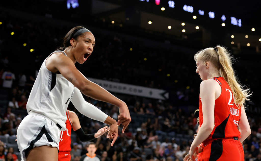 Las Vegas Aces center A'ja Wilson, left, reacts after making a basket and drawing a foul during the first half of an WNBA basketball game against the Portland Fire Tuesday, July 28, 2026, in Las Vegas. (Steve Marcus/Las Vegas Sun via AP)
