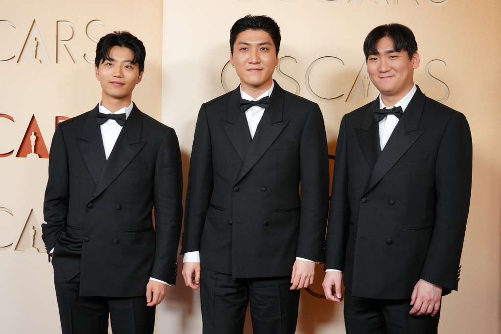 Yu Han Lee, from left, Zhun, and Hee Dong Nam arrive at the Oscars on Sunday, March 15, 2026, at the Dolby Theatre in Los Angeles. (Photo by Jordan Strauss/Invision/AP)