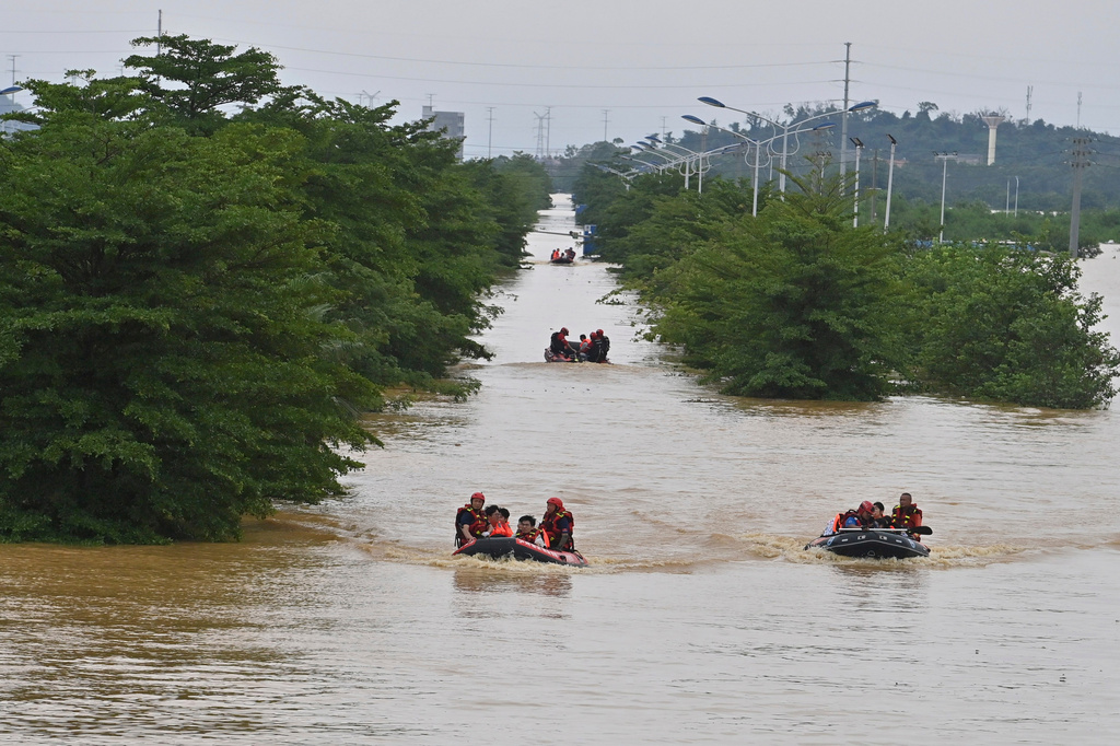 In this photo released by Xinhua News Agency, rescuers evacuate stranded teachers and students at Xijiang education park in the aftermath of tropical storm Maysak in Guigang City, south China's Guangxi Zhuang Autonomous Region, July 8, 2026. (Zhou Hua/Xinhua via AP)