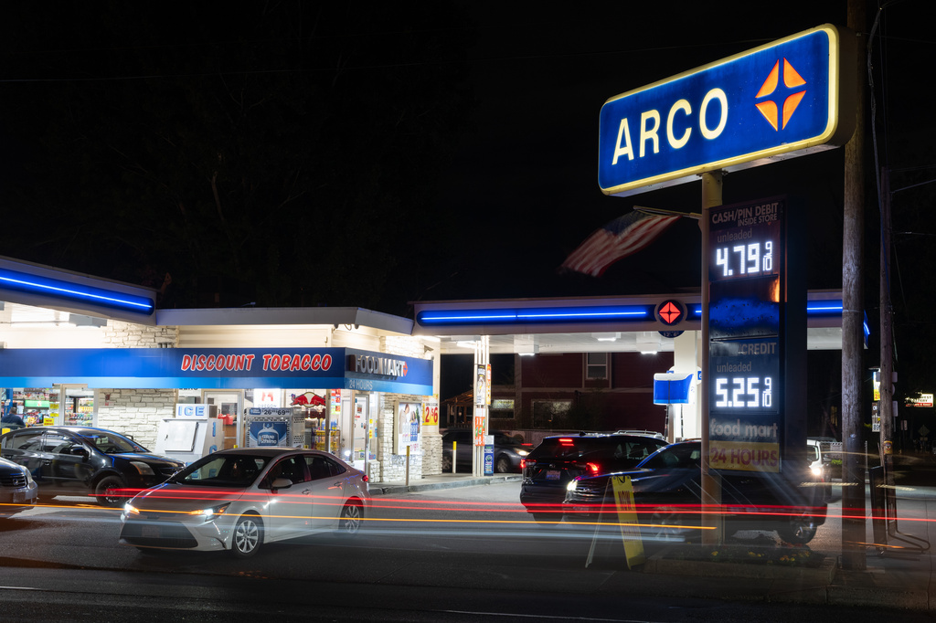 In this image taken with a slow shutter speed, vehicles move past a gas station on Wednesday, May 6, 2026, in Portland, Ore. (AP Photo/Jenny Kane)