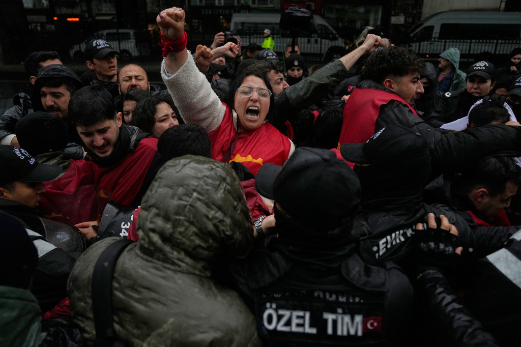 Union members scuffle with Turkish police officers as they try to march towards Taksim square in Istanbul, Turkey, Friday, May 1, 2026, during Labor Day celebrations. (AP Photo/Khalil Hamra)