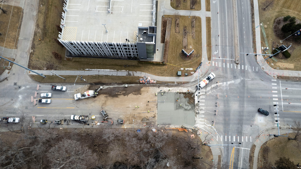 Crews work to fill a sinkhole near the intersection of Pacific and South 67th Street in Omaha, Neb., on March 2, 2026. (Naomi Delkamiller/Flatwater Free Press via AP)
