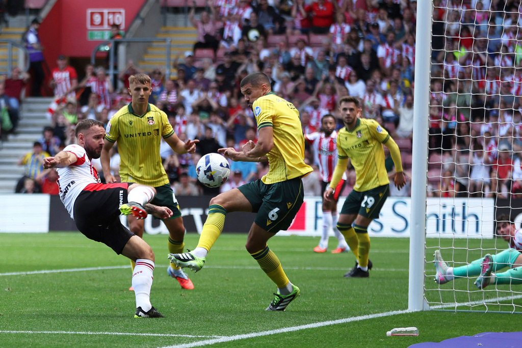 Southampton's Adam Armstrong, left, attempts a shot towards goal but is blocked by Wrexham's Conor Coady during their English Football League Championship match at St Mary's Stadium, Southampton, England, Saturday, Aug. 9, 2025. (Steven Paston/PA via AP)