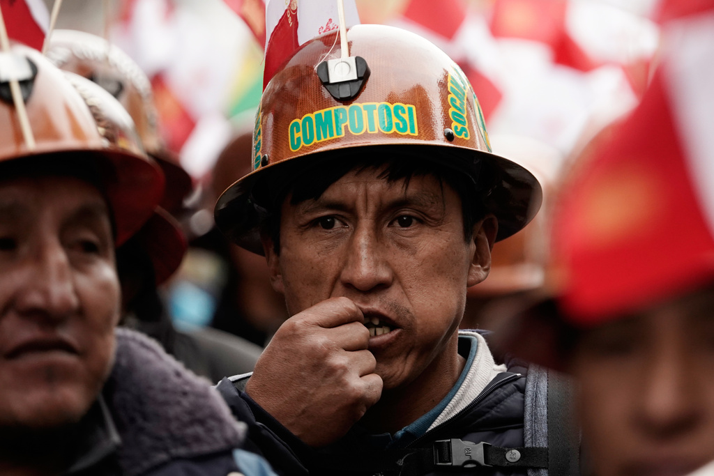 A miner chews coca during a march to protest President Rodrigo Paz's decision to remove fuel subsidies in La Paz, Bolivia Monday, Dec. 22, 2025. (AP Photo/Freddy Barragan)