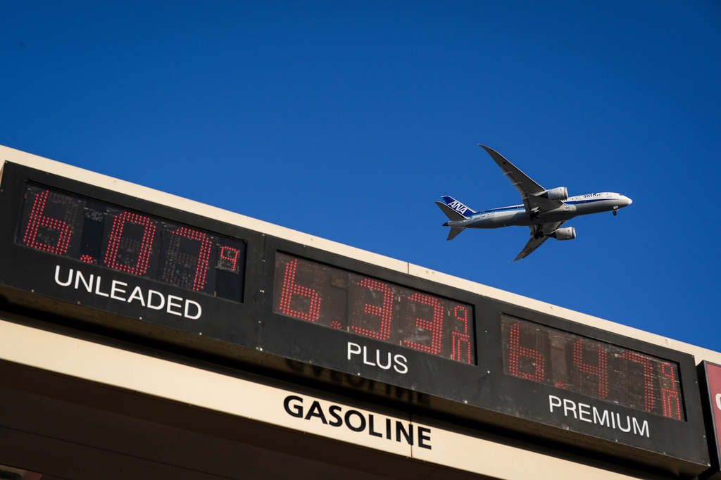 FILE - An ANA jet flies above a gas station in Inglewood, Calif., on May 6, 2026. (AP Photo/Jae C. Hong, File)