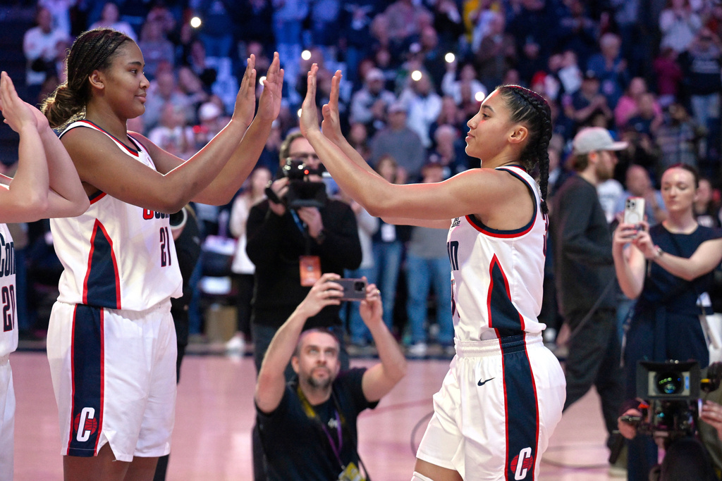 FILE - UConn forward Sarah Strong (21) and guard Azzi Fudd (35) slap hands as they are introduced in an NCAA college basketball game against Marquette, Sunday, March 2, 2025, in Storrs, Conn. (AP Photo/Jessica Hill, File)