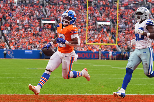Denver Broncos' RJ Harvey (12) catches a touchdown pass in front of Dallas Cowboys' Kaiir Elam (20) in the second half of an NFL football game Sunday, Oct. 26, 2025, in Denver. (AP Photo/David Zalubowski) Denver Broncos' RJ Harvey (12) catches a touchdown pass in front of Dallas Cowboys' Kaiir Elam (20) in the second half of an NFL football game Sunday, Oct. 26, 2025, in Denver. (AP Photo/David Zalubowski)