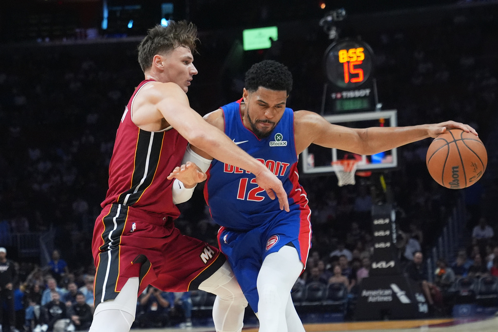 Miami Heat guard Pelle Larsson defends Detroit Pistons forward Tobias Harris (12) during the first half of an NBA basketball game Sunday, March 8, 2026, in Miami. (AP Photo/Marta Lavandier)