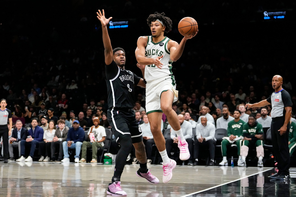 Milwaukee Bucks center Jericho Sims (00) passes the ball during the first half of an NBA basketball game against Brooklyn Nets, Tuesday, April 7, 2026, in New York. (AP Photo/Yuki Iwamura)