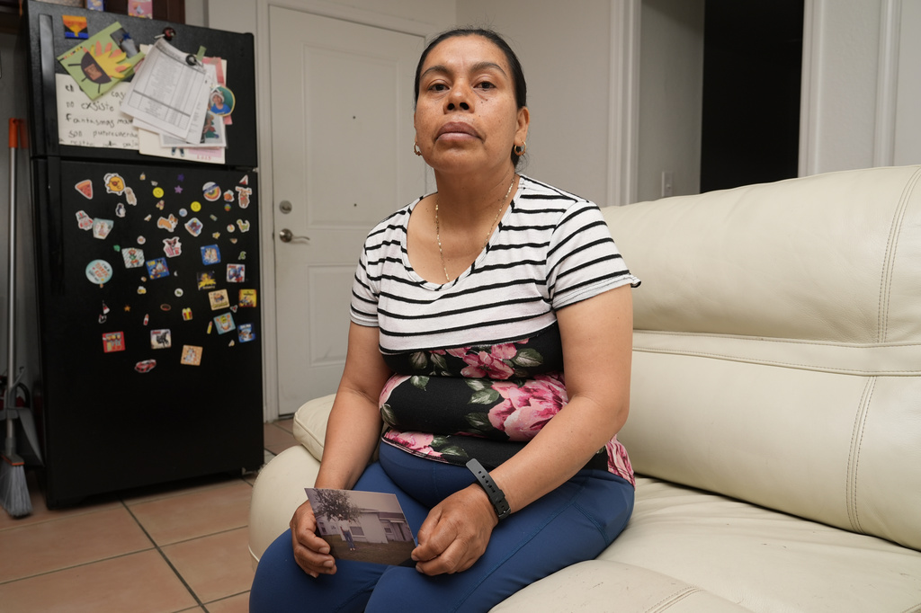 Maria Jose Gonzalez holds a photo of her husband, Jose-Antonio Segismundo, who was detained for six months at "Alligator Alcatraz," April 16, 2026, in Wimauma, Fla. (AP Photo/Chris O'Meara)