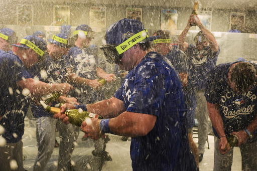 Toronto Blue Jays' Davis Schneider, center, celebrates with teammates in the clubhouse after their baseball game against the Kansas City Royals, Sunday, Sept. 21, 2025, in Kansas City, Mo. (AP Photo/Charlie Riedel) Toronto Blue Jays' Davis Schneider, center, celebrates with teammates in the clubhouse after their baseball game against the Kansas City Royals, Sunday, Sept. 21, 2025, in Kansas City, Mo. (AP Photo/Charlie Riedel)