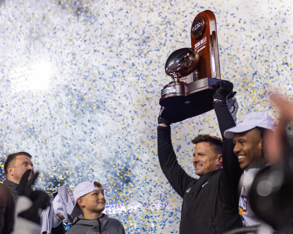 James Madison head coach Bob Chesney and James Madison running back Wayne Knight (3) celebrate after winning the Sun Belt championship NCAA college football game, Friday, Dec. 5, 2025, in Harrisonburg, Va. (AP Photo/Robert Simmons)