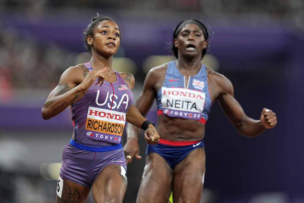 United States' Sha'Carri Richardson and Britain's Daryll Neita finish a women's 100 meters semifinal at the World Athletics Championships in Tokyo, Sunday, Sept. 14, 2025. (AP Photo/Petr David Josek)