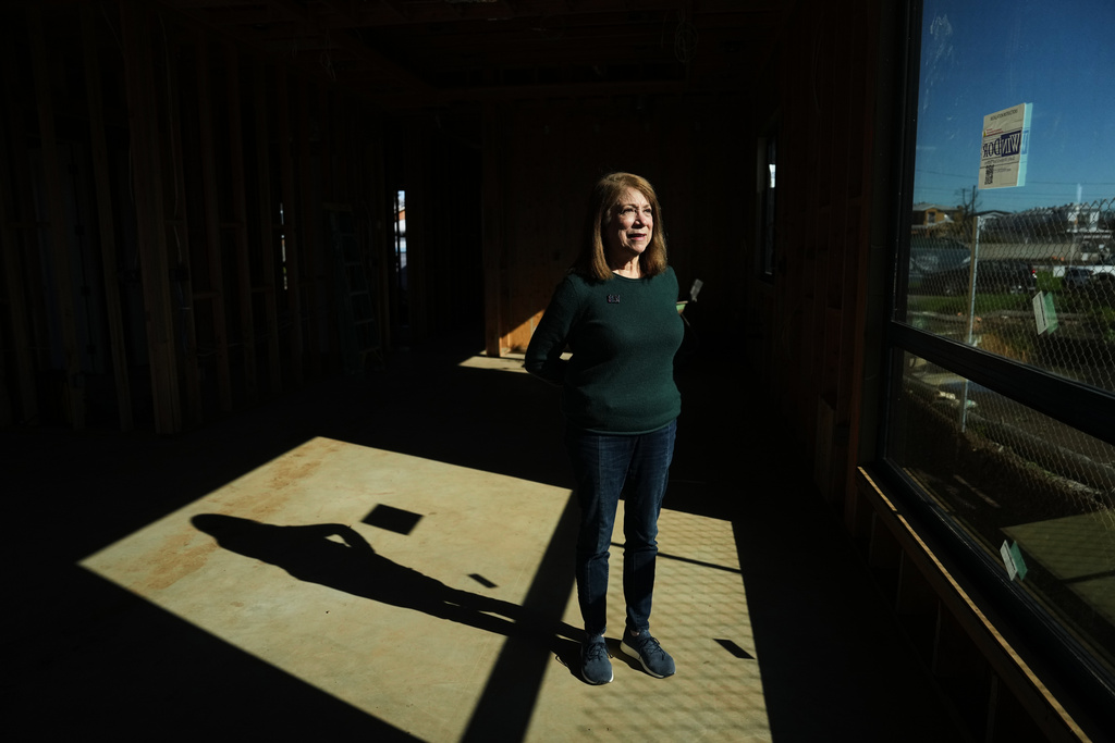 Gail Kass stands inside her home being rebuilt on the one-year anniversary of the Palisades Fire in the Pacific Palisades neighborhood of Los Angeles Wednesday, Jan. 7, 2026. (AP Photo/Jae C. Hong)