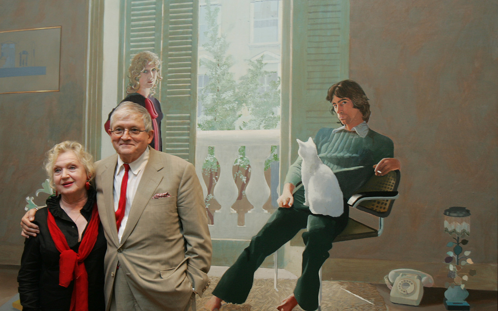 FILE - British artist David Hockney, stands next to his friend and model Celia Birtwell, in front of one of his most famous works ' Mr and Mrs Clark and Percy' at the National Portrait Gallery in London, Wednesday Oct. 11, 2006. (AP Photo/Alastair Grant, File)
