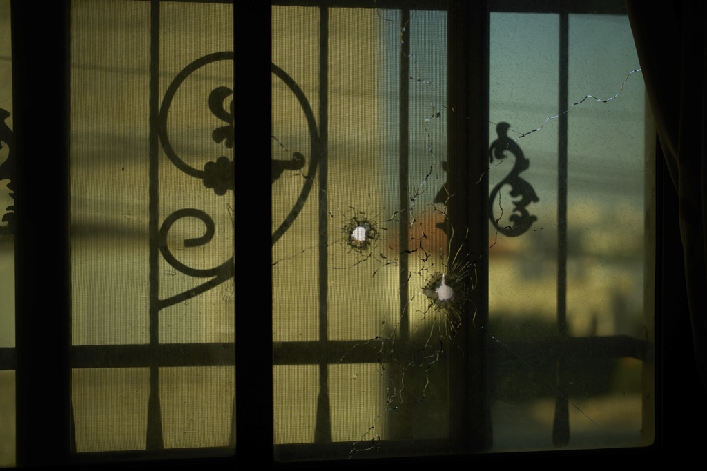 Bullet holes are visible on March 11, 2025, in the window of the house where 2-year-old Layla Al-Khatib was killed by Israeli gunfire in the village of Muthallath ash-Shuhada near Jenin. (AP Photo/Leo Correa)