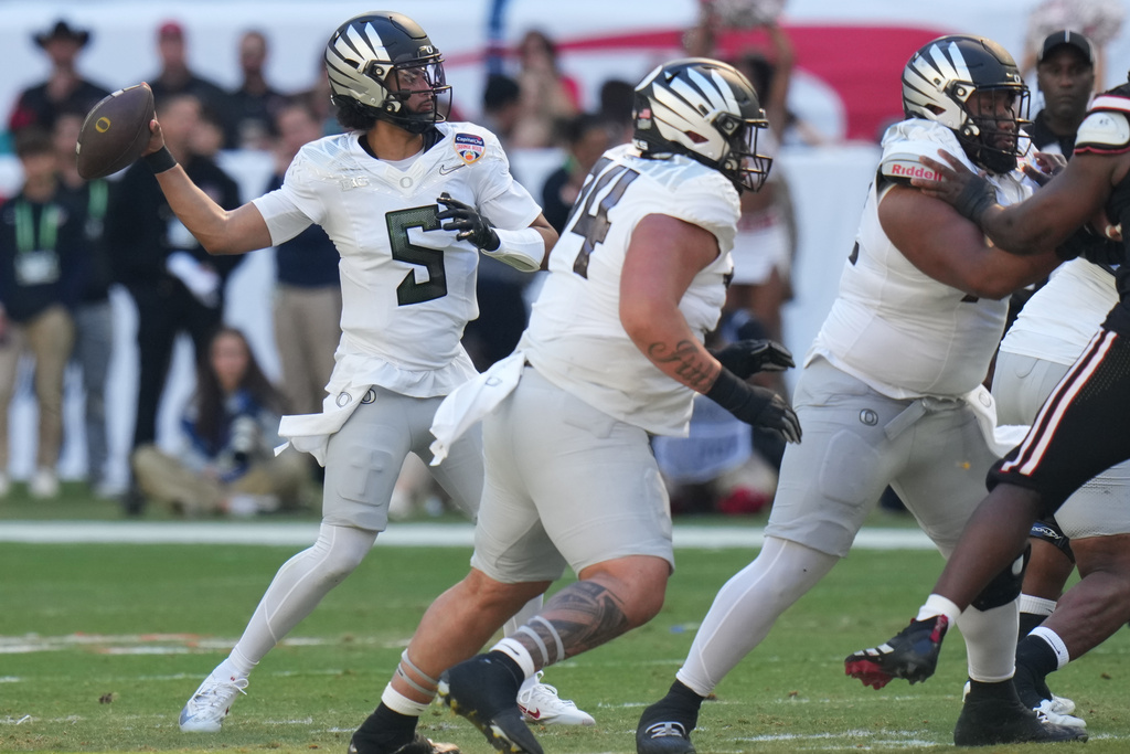 Oregon quarterback Dante Moore (5) looks to pass during the first half of the Orange Bowl College Football Playoff quarterfinal game against Texas Tech, Thursday, Jan. 1, 2026, in Miami Gardens, Fla. (AP Photo/Lynne Sladky)