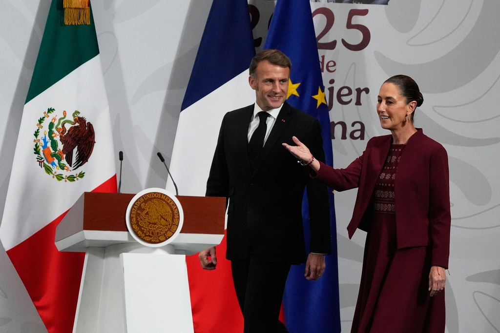France's President Emmanuel Macron, left, and Mexican President Claudia Sheinbaum arrive to give a joint news conference at the National Palace in Mexico City, Friday, Nov. 7, 2025. (AP Photo/Marco Ugarte)