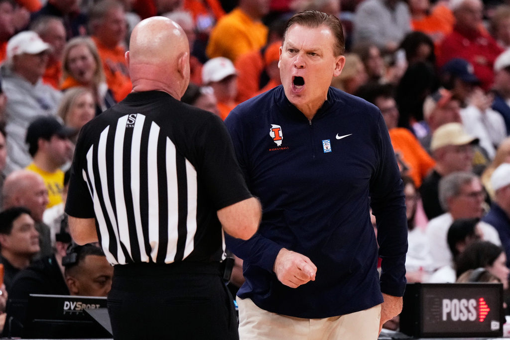 Illinois head coach Brad Underwood, right, reacts to a call during the second half of an NCAA college basketball game against Wisconsin in the quarterfinals of the Big 10 Conference tournament, Friday, March 13, 2026, in Chicago. (AP Photo/Nam Y. Huh)
