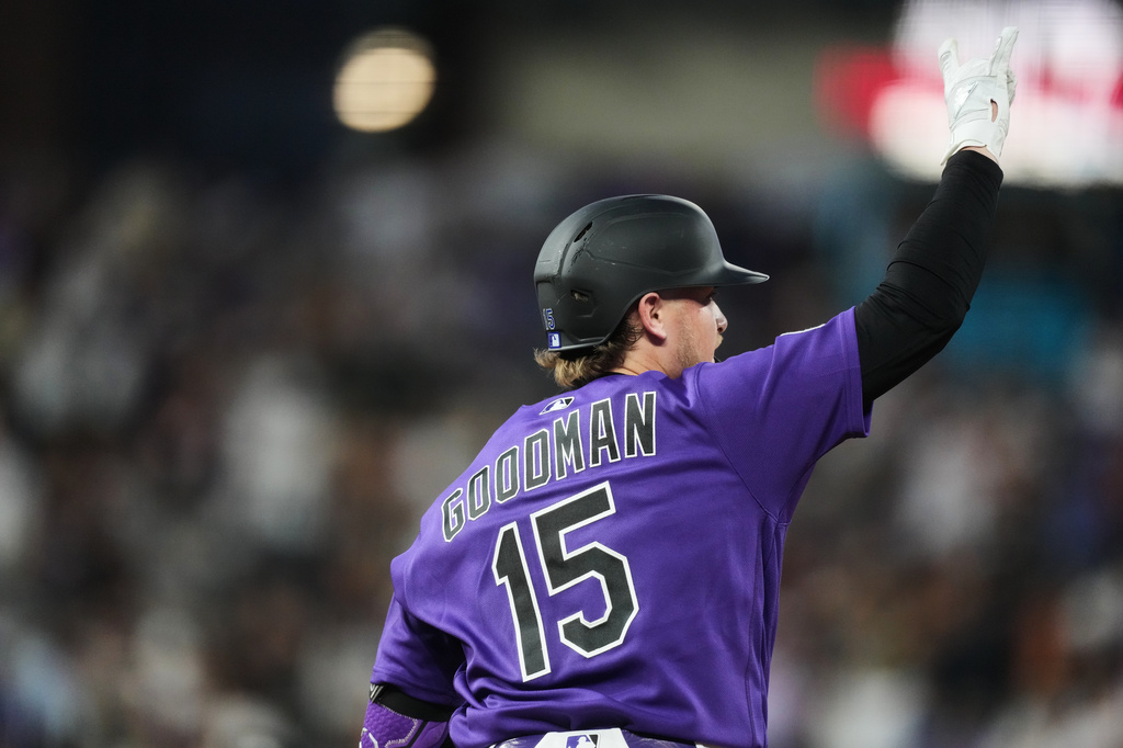 Colorado Rockies' Hunter Goodman gestures to the bullpen as he circles the bases after hitting a solo home run off Kansas City Royals relief pitcher Alex Lange in the seventh inning of a baseball game Saturday, Aug. 1, 2026, in Denver. (AP Photo/David Zalubowski)