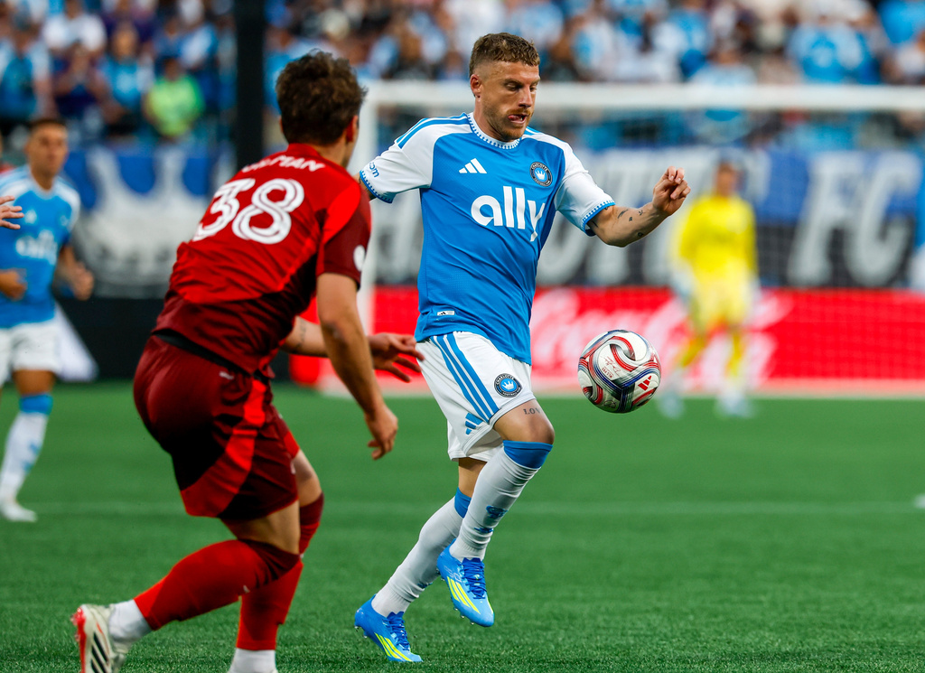 Charlotte FC midfielder Pep Biel, right, moves the ball against Toronto FC defender Jackson Gilman (38) during the first half of an MLS soccer match in Charlotte, N.C., Saturday, May 16, 2026. (AP Photo/Nell Redmond)