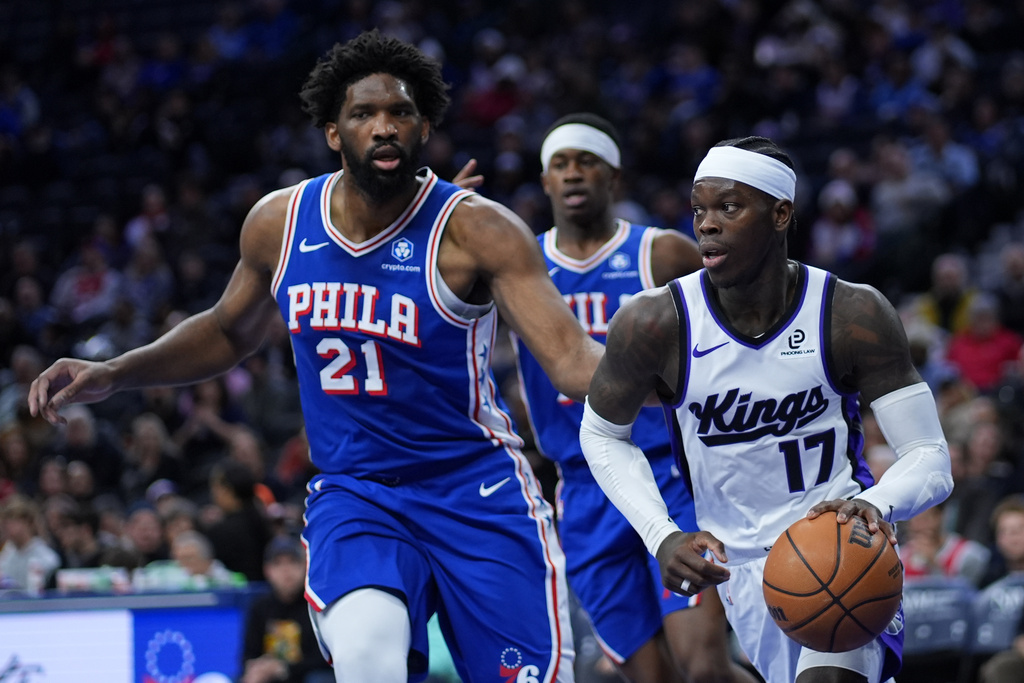 Sacramento Kings' Dennis Schroder, right, tries to get past Philadelphia 76ers' Joel Embiid during the first half of an NBA basketball game Thursday, Jan. 29, 2026, in Philadelphia. (AP Photo/Matt Slocum)