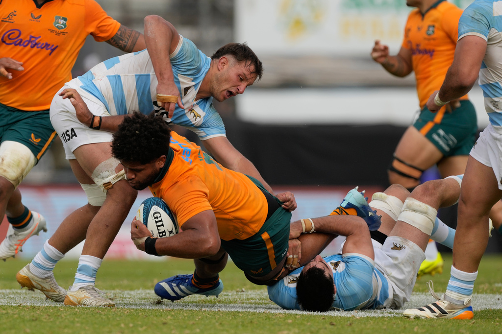 Australia Rob Valetini, center, is tackled by Argentina Benjamin Grondona, right, during a rugby test match in Jujuy, Argentina, Saturday, Aug. 29, 2026. (AP Photo/Gustavo Garello)
