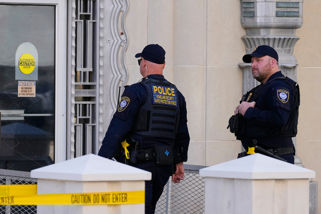 Officers with the Department of Homeland Security walk inside the Eldon B. Mahon U.S. Courthouse during a trial for nine people connected to a 2025 shooting outside an ICE detention facility, in Fort Worth, Texas, Thursday, March 12, 2026. (AP Photo/Tony Gutierrez)