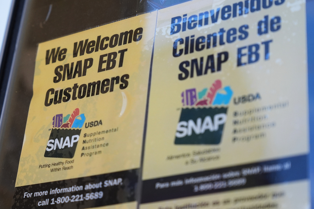 A SNAP EBT information sign is displayed outside of a convenience store in Baltimore, Monday, Nov. 10, 2025. (AP Photo/Stephanie Scarbrough)
