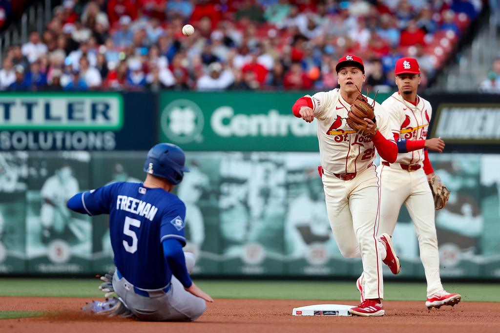 St. Louis Cardinals' JJ Wetherholt turns a double play over Los Angeles Dodgers' Freddie Freeman during the first inning of a baseball game Saturday, May 2, 2026, in St. Louis. (AP Photo/Scott Kane)