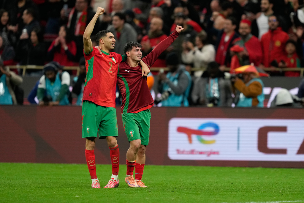 Morocco's Achraf Hakimi, left, and Brahim Abdelkader Díaz celebrate after winning the penalty shootout during the Africa Cup of Nations semi-final match between Nigeria and Morocco in Rabat, Morocco, Wednesday, Jan. 14, 2026. (AP Photo/Mosa'ab Elshamy)
