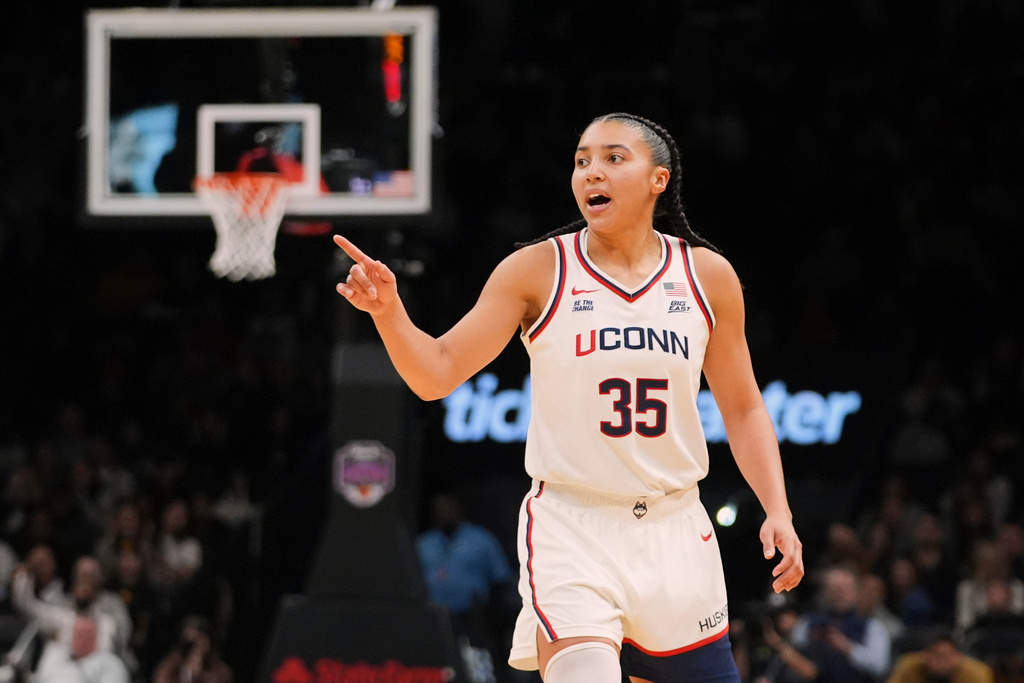 UConn's Azzi Fudd (35) gestures to teammates after making a three-point shot during the second half of an NCAA college basketball game against the Iowa Saturday, Dec. 20, 2025, in New York. (AP Photo/Frank Franklin II)