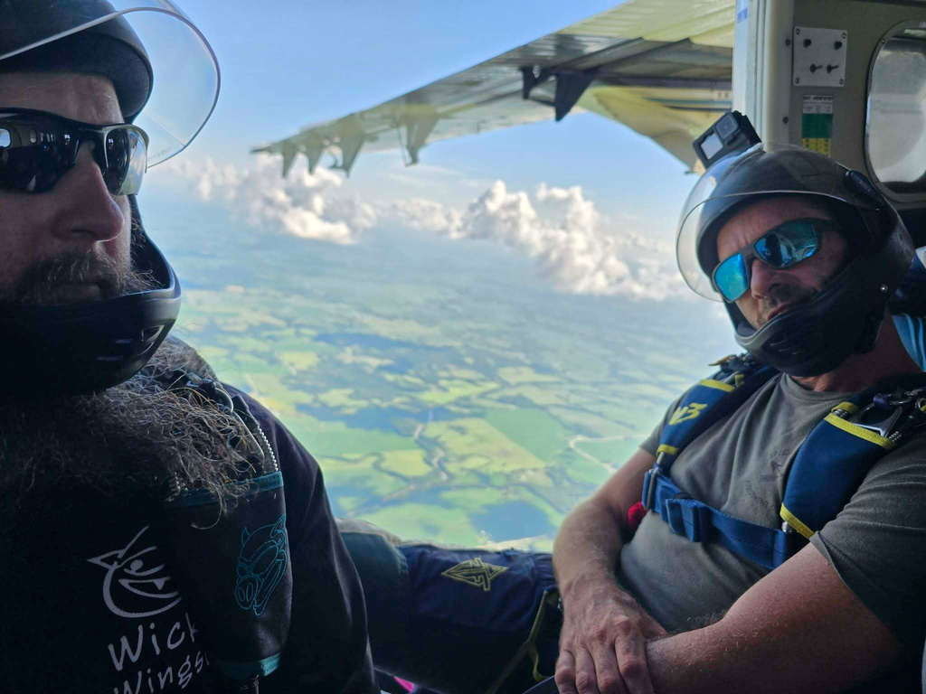 Matt Swope, left, and another skydiver waiting to jump over Butler, Mo., June 28, 2025. (Justin Williams via AP)