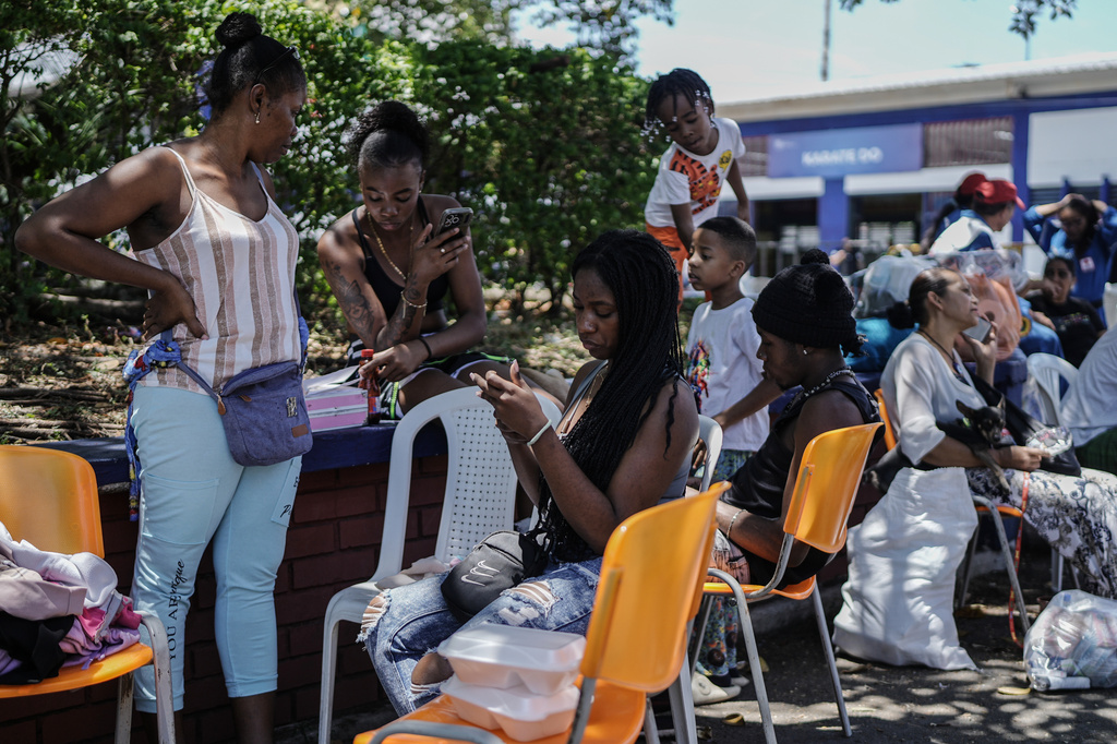 People affected by the earthquake wait for treatment at a health post three days after it hit Cali, Colombia, Thursday, Aug. 13, 2026. (AP Photo/Ivan Valencia)