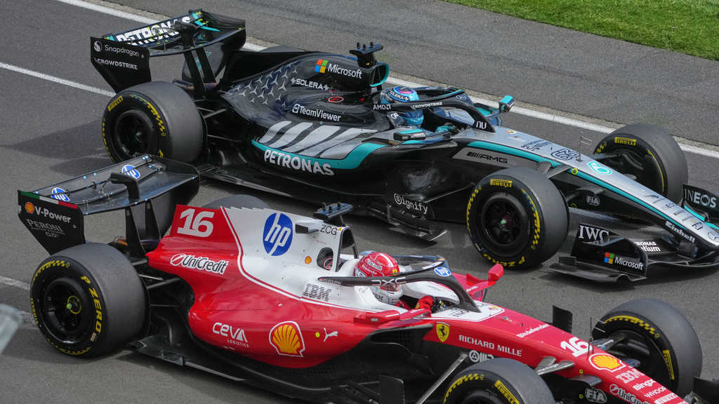 Ferrari driver Charles Leclerc, left, of Monaco passes Mercedes driver George Russell of Britain during the Australian Formula One Grand Prix at Albert Park, in Melbourne, Australia, Sunday, March 8, 2026. (AP Photo/Asanka Brendon Ratnayake)
