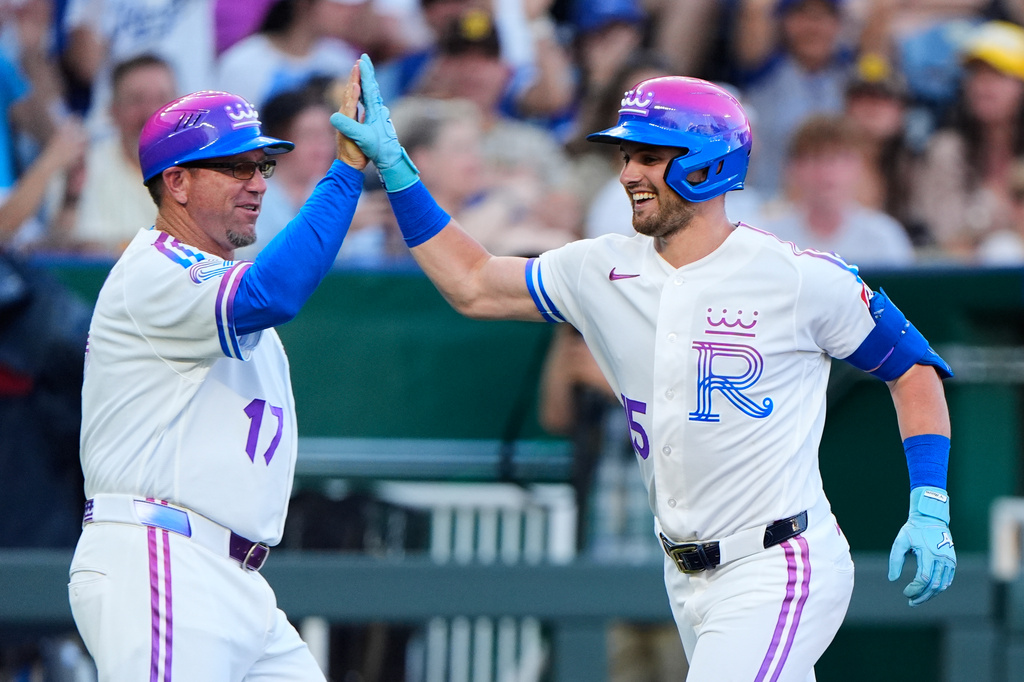 Kansas City Royals' Lane Thomas celebrates with third base coach Vance Wilson (17) after hitting a solo home run during the second inning of a baseball game against the San Diego Padres, Friday, July 17, 2026, in Kansas City, Mo. (AP Photo/Charlie Riedel)