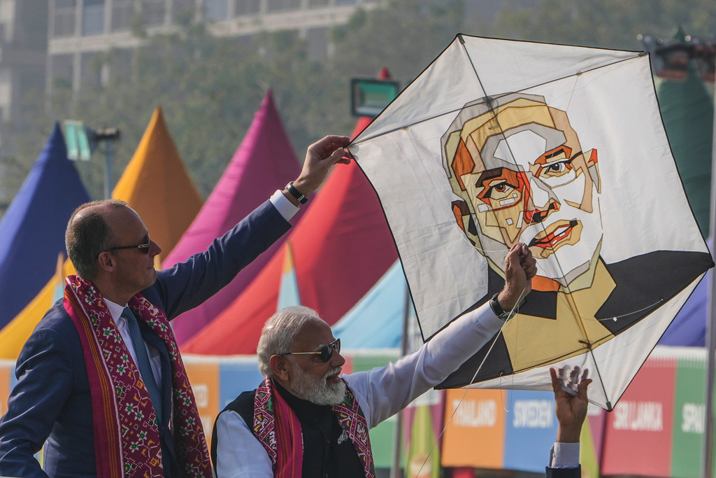German Chancellor Friedrich Merz, left, and Indian Prime Minister Narendra Modi prepare to fly a kiteduring the inauguration of International kite festival in Ahmedabad, India, Monday, Jan. 12, 2026. (AP Photo/Ajit Solanki)