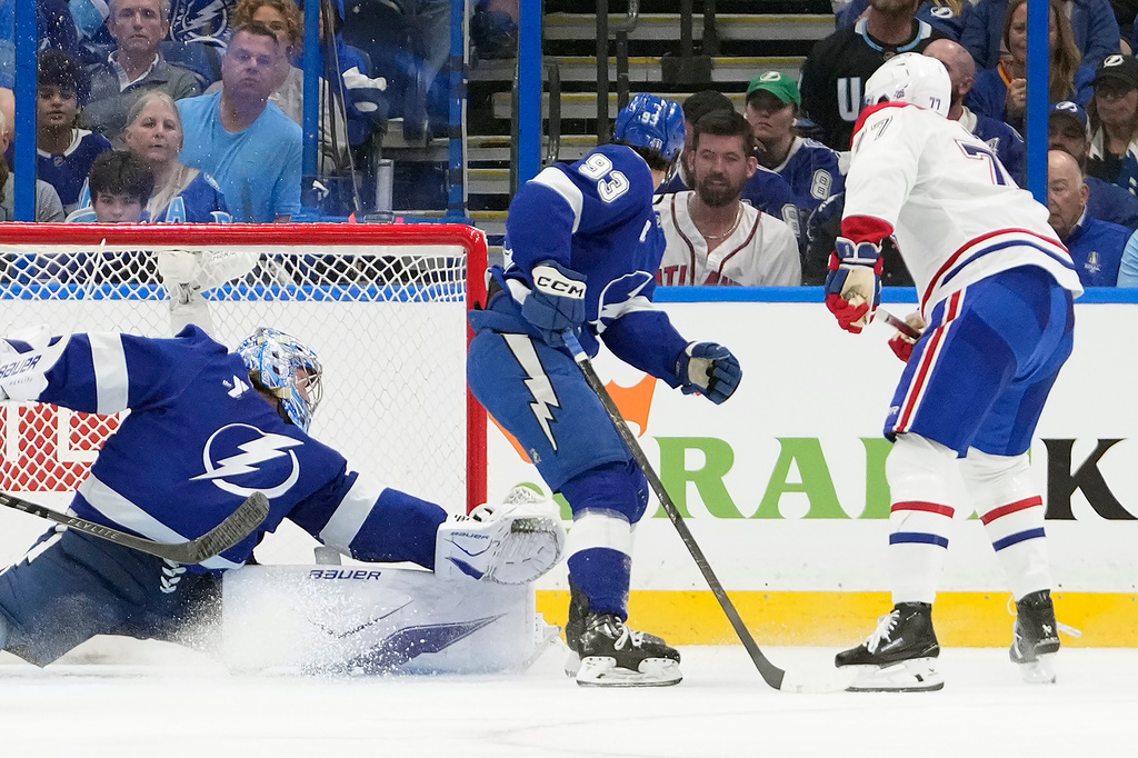 Montréal Canadiens center Kirby Dach (77) watches his shot get past Tampa Bay Lightning goaltender Andrei Vasilevskiy (88) and center Gage Goncalves (93) for a goal during the second period in Game 5 of an NHL hockey Stanley Cup first-round playoff series, Wednesday, April 29, 2026, in Tampa, Fla. (AP Photo/Chris O'Meara)