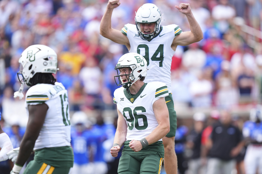 Baylor place kicker Connor Hawkins (96) reacts to scoring the game winning field goal with teammate Palmer Williams (94) during the second overtime of an NCAA college football game against SMU Saturday, Sept. 6, 2025, in Dallas. (AP Photo/LM Otero)