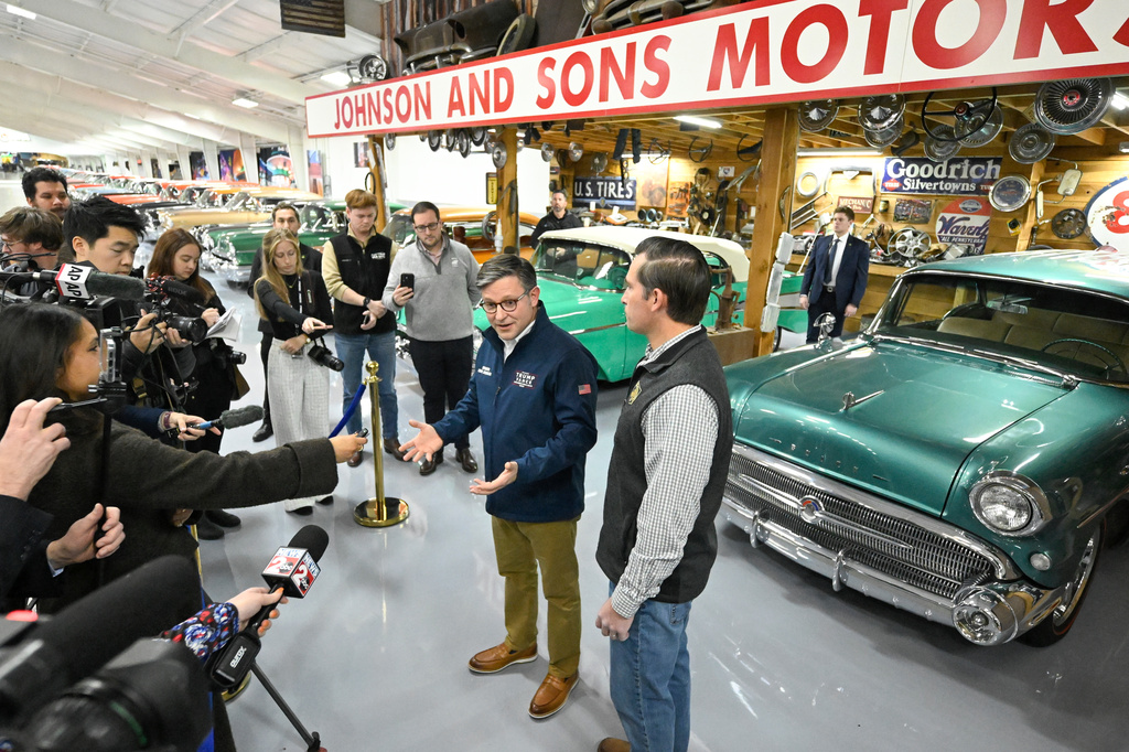 U.S. House Speaker Mike Johnson speaks to the media as he stumps for Republican U.S Congressional candidate for the seventh district Matt Van Epps, right, during a rally inside a supporter's garage featuring a classic car collection Monday, Dec. 1, 2025, in Franklin, Tenn. (AP Photo/John Amis)