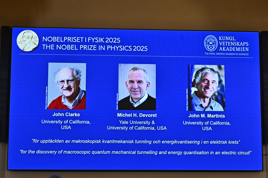 Photos of John Clarke, Michel H Devoret and John M. Martinis are pictured on a screen after they were announced as winners of the Nobel Prize in Physics, at the Nobel Assembly of the Karolinska Institutet, in Stockholm, Sweden, Tuesday, Oct. 7, 2025. (Christine Olsson/TT News Agency via AP)