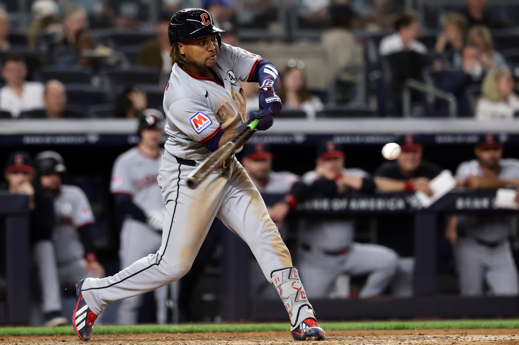 Cleveland Guardians' José Ramírez hits a run scoring double during the seventh inning of a baseball game against the New York Yankees, Tuesday, June 2, 2026, in New York. (AP Photo/Adam Hunger)