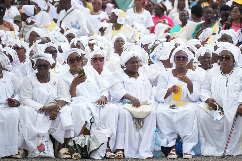 Faithful wait for Pope Leo XIV in the Japoma Stadium before the start of a Mass, in Douala, Cameroon, Friday, April 17, 2026 on the fifth day of his 11-day pastoral visit to Africa. (AP Photo/Andrew Medichini)