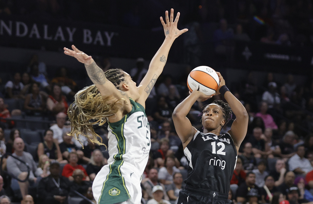 Las Vegas Aces guard Chelsea Gray (12) looks to shoot over Seattle Storm forward Gabby Williams, left, during the first half of a WNBA basketball game Friday, Aug. 8, 2025, in Las Vegas. (Steve Marcus/Las Vegas Sun via AP)