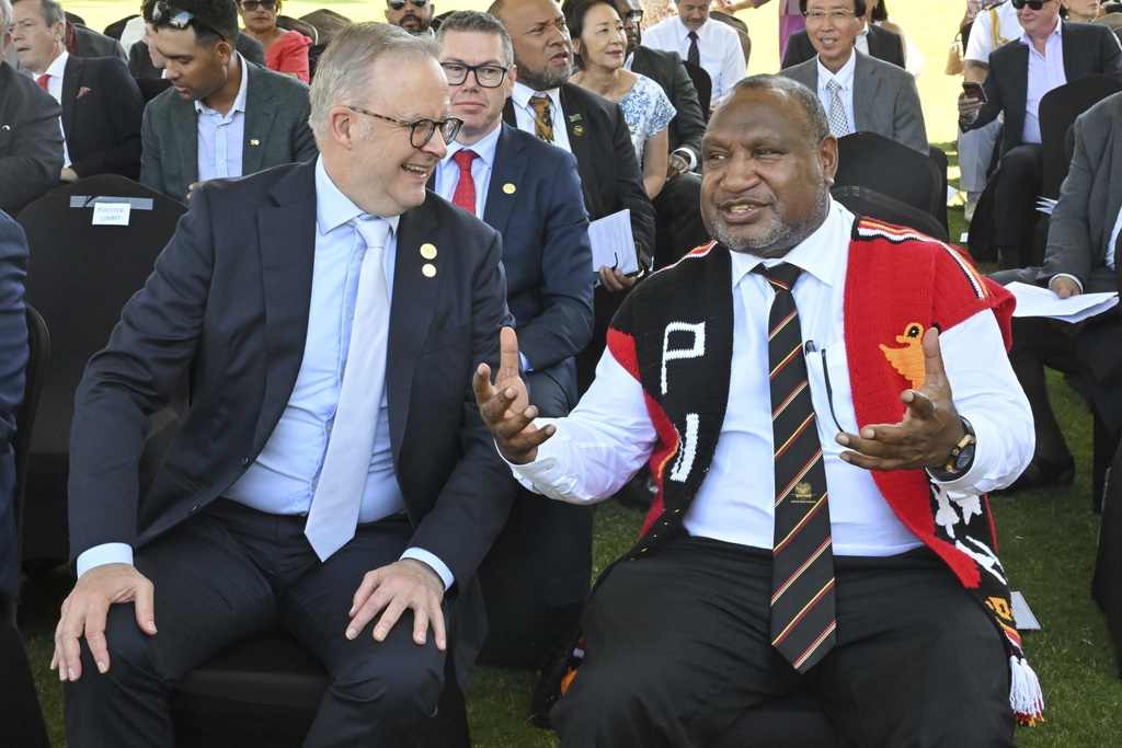 Australia's Prime Minister Anthony Albanese, left, and Papua New Guinea's Prime Minister James Marape attend a flag lowering ceremony in Port Moresby, Papua New Guinea, Tuesday, Sept. 16, 2025. (Mick Tsikas/AAP Image via AP)
