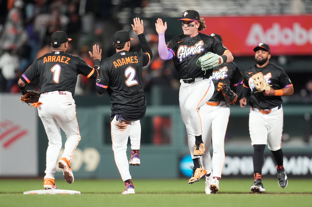 San Francisco Giants' Luis Arraez, from left, celebrates with Willy Adames (2), Harrison Bader, Jung Hoo Lee and Heliot Ramos after a baseball game against the Philadelphia Phillies in San Francisco, Tuesday, April 7, 2026. (AP Photo/Jeff Chiu)